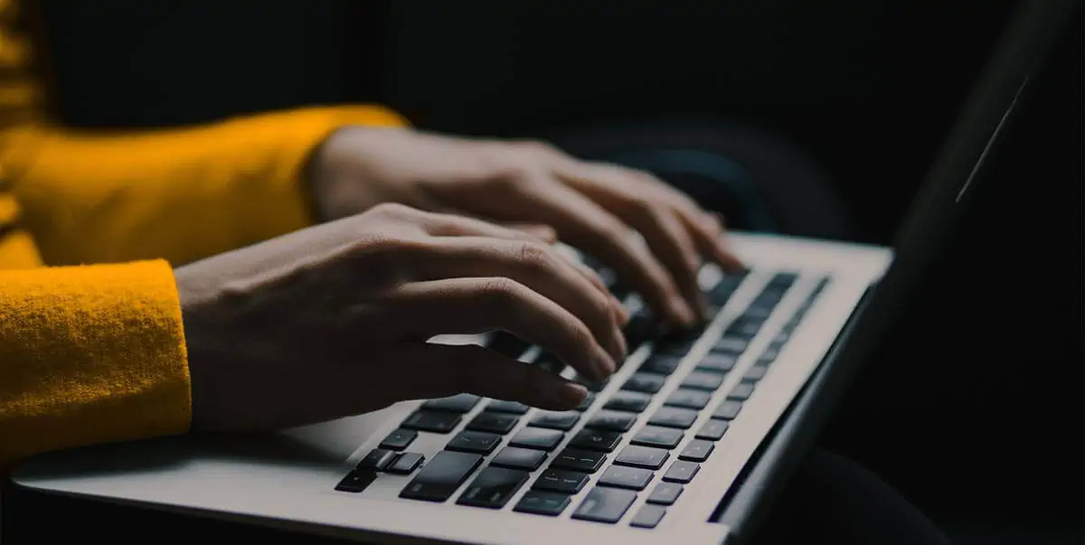 Woman typing on a laptop